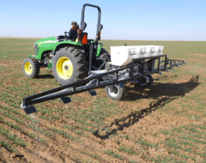 NPKS applicator.  Gandy boxes hold each fertilizer and a pto driven fan blew the fertilizer down the boom.